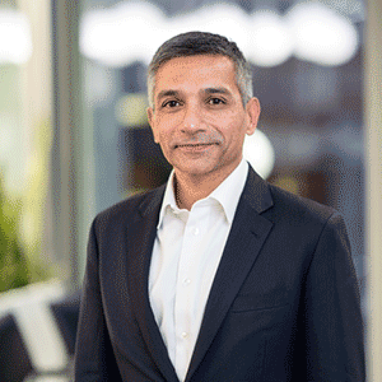 Portrait of Irfan Hussain, Group Chief Information Officer, in a business setting.