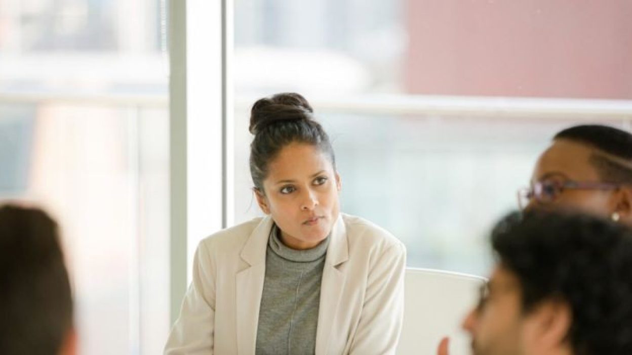 Photograph of woman and work colleagues