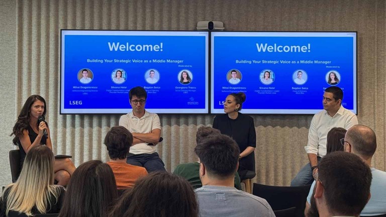 LSEG WIN tech committee panel discussion in front of an audience, with ‘Welcome!’ displayed on screens behind.