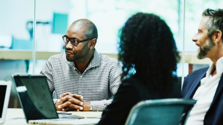 three people in a meeting